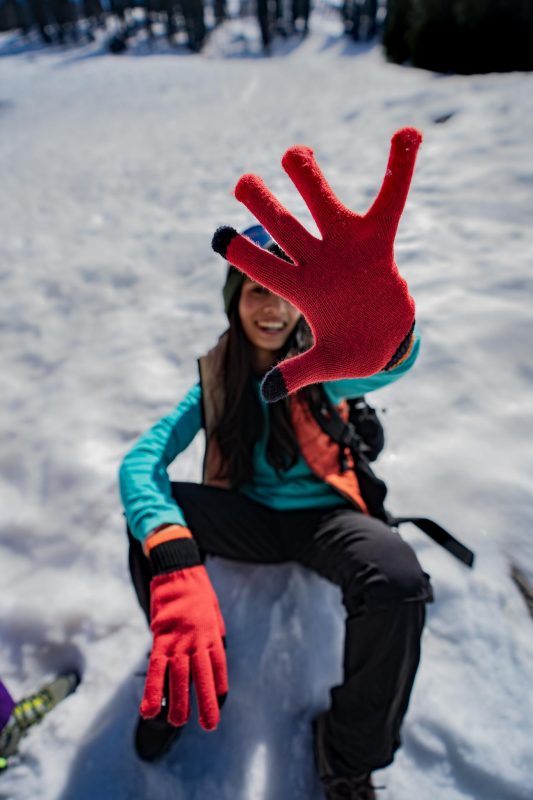 girl wearing winter gloves in the snow