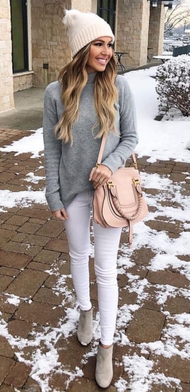 woman in grey turtleneck and white jeans in winter