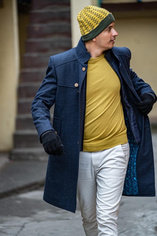 man wearing a long coat as winter outfits